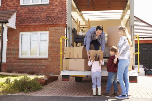 Removal van and moving team in a residential street in Ealing