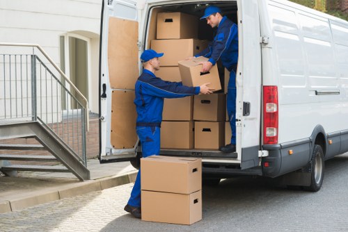 Packed moving boxes and furniture ready for transport in West London