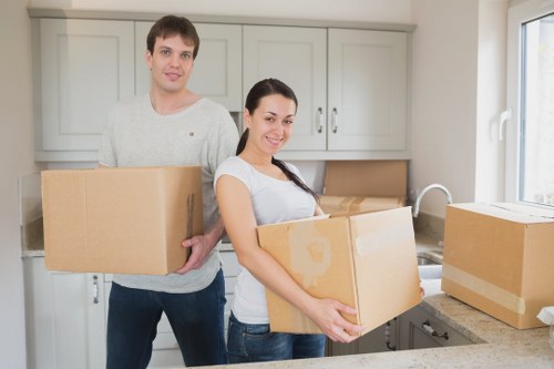 Packed household boxes and furniture ready for removal from a West London home