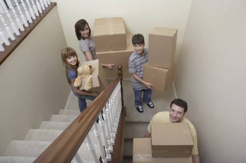 Professional furniture movers working in an Ealing flat
